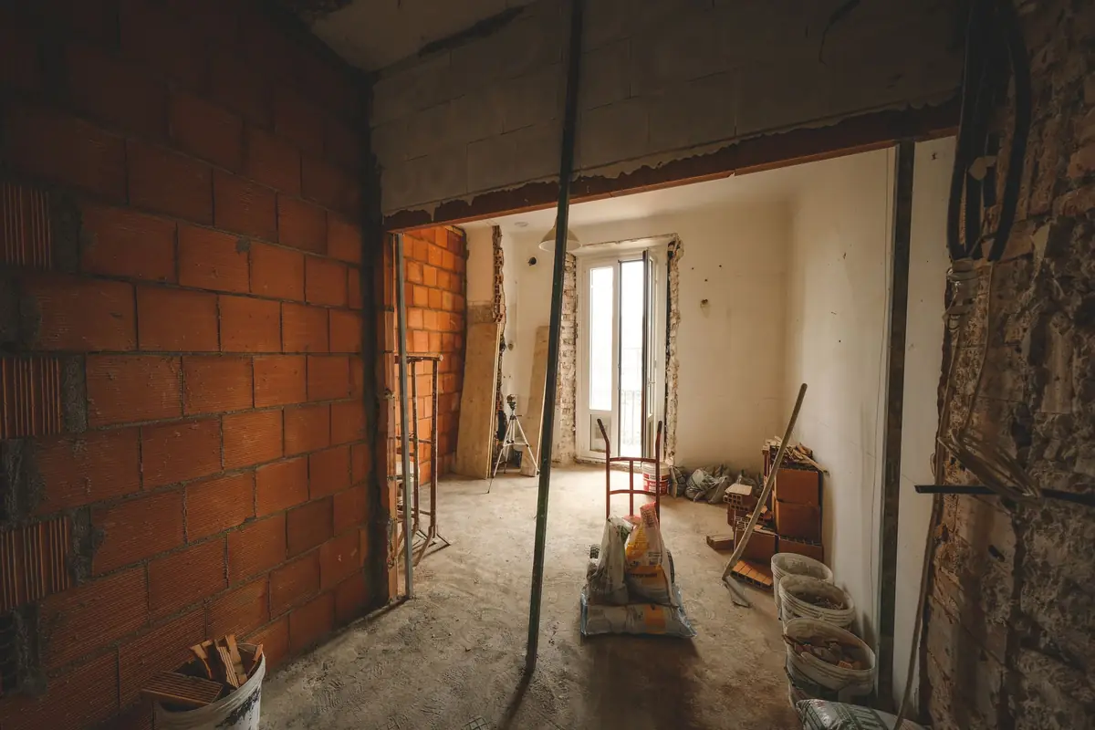 A wide new opening between two rooms during building work.