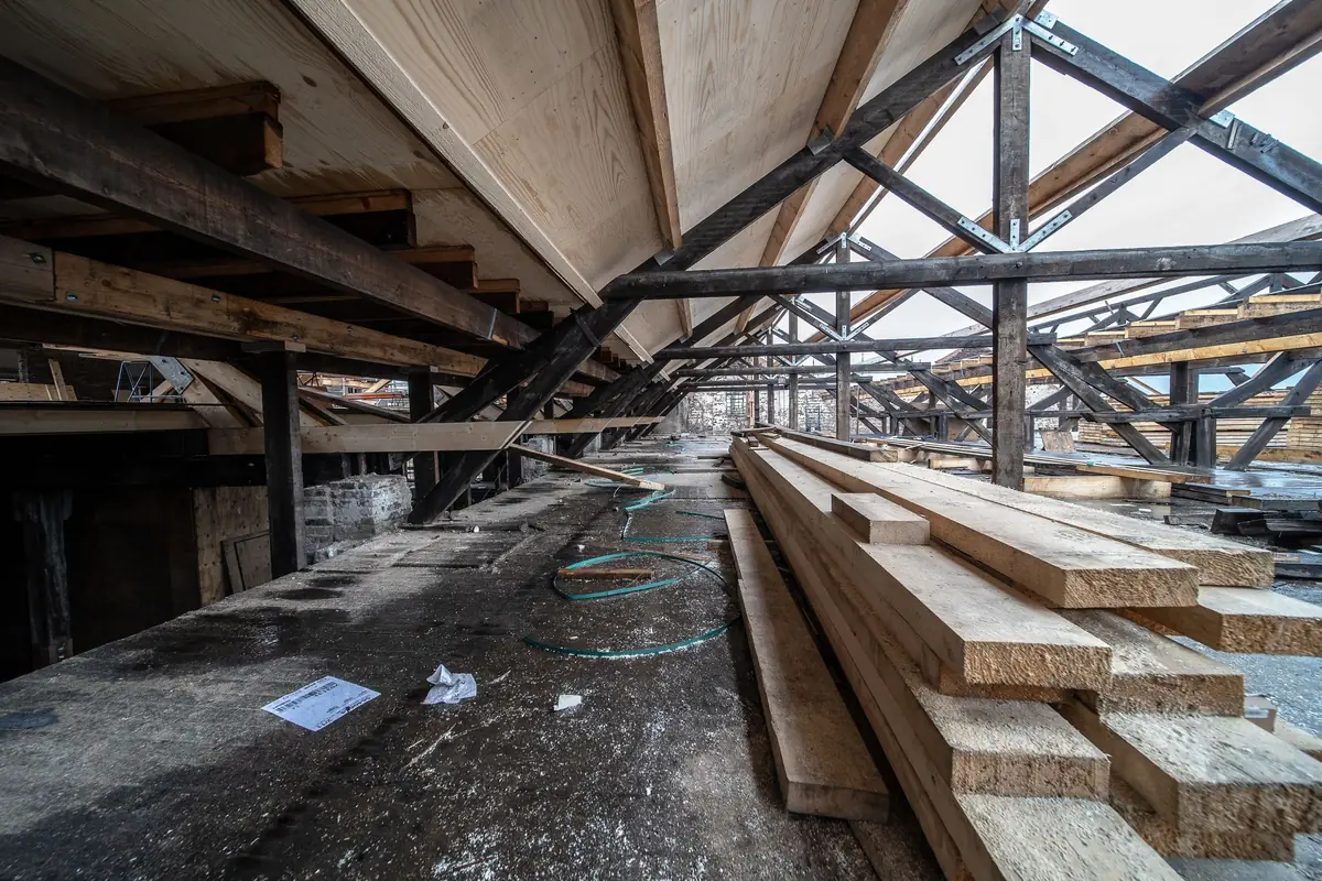 Timber beams and joists in a roof under construction.